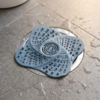 Spiral shower drain hair catcher shown in a shower drain