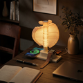 Spiral tree table lamp with wireless charger glowing on a desk